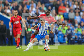 2021-08-21 - Leandro Trossard (11) of Brighton & Hove Albion tussles with Oghenekaro Etebo (4) of Watford during the English championship Premier League football match between Brighton and Hove Albion and Watford on August 21, 2021 at the American Express Community Stadium in Brighton and Hove, England - Photo Nigel Keene / ProSportsImages / DPPI - BRIGHTON AND HOVE ALBION VS WATFORD - ENGLISH PREMIER LEAGUE - SOCCER