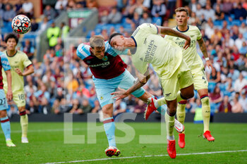 2021-09-18 - Burnley forward Chris Wood (9) battles in the air with Arsenal defender Gabriel (6) during the Premier League match between Burnley and Arsenal at Turf Moor, Burnley, England on 18 September 2021. Photo Simon Davies /ProSportsImages / DPPI - BURNLEY VS ARSENAL - ENGLISH PREMIER LEAGUE - SOCCER