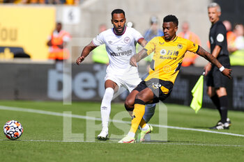 2021-09-18 - Nelson Semedo (22) of Wolverhampton Wanderers tussles with Rico Henry (3) of Brentford during the Premier League match between Wolverhampton Wanderers and Brentford at Molineux, Wolverhampton, England on 18 September 2021. Photo Nigel Keene / ProSportsImages / DPPI - WOLVERHAMPTON WANDERERS VS BRENTFORD - ENGLISH PREMIER LEAGUE - SOCCER