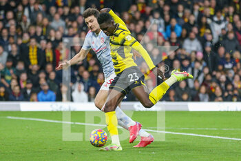 2021-11-21 - Watford forward Ismaila Sarr (23) shoots at goal, Manchester United defender Harry Maguire during the English championship Premier League football match between Watford and Manchester United on November 20, 2021 at Vicarage Road in Watford, England - WATFORD VS MANCHESTER UNITED - ENGLISH PREMIER LEAGUE - SOCCER
