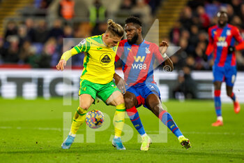 2021-12-28 - Odsonne Edouard (22) of Crystal Palace tussles with Przemyslaw Placheta (11) of Norwich City during the English championship Premier League football match between Crystal Palace and Norwich City on December 28, 2021 at Selhurst Park in London, England - CRYSTAL PALACE VS NORWICH CITY - ENGLISH PREMIER LEAGUE - SOCCER
