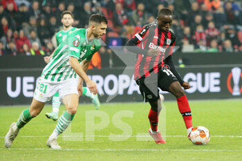 2021-11-04 - Moussa Diaby of Bayer Leverkusen and Guido Rodriguez of Real Betis Balompie during the UEFA Europa League, Group G football match between Bayer Leverkusen and Real Betis Balompie on November 4, 2021 at BayArena in Leverkusen, Germany - BAYER LEVERKUSEN VS REAL BETIS BALOMPIE - UEFA EUROPA LEAGUE - SOCCER