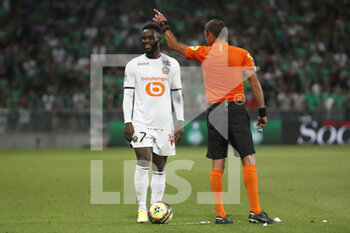 2021-08-21 - Jonathan BAMBA of Lille and referee Mikael LESAGE during the French championship Ligue 1 football match between AS Saint-Etienne and LOSC Lille on August 21, 2021 at Geoffroy-Guichard stadium in Saint-Etienne, France - Photo Romain Biard / Isports / DPPI - AS SAINT-ETIENNE (ASSE) VS LILLE OSC (LOSC) - FRENCH LIGUE 1 - SOCCER