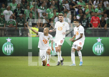 2021-08-21 - Burak Yilmaz of Lille celebrates his goal with Xeka and Reinildo Mandava during the French championship Ligue 1 football match between AS Saint-Etienne (ASSE) and Lille OSC (LOSC) on August 21, 2021 at Stade Geoffroy-Guichard in Saint-Etienne, France - Photo Jean Catuffe / DPPI - AS SAINT-ETIENNE (ASSE) VS LILLE OSC (LOSC) - FRENCH LIGUE 1 - SOCCER