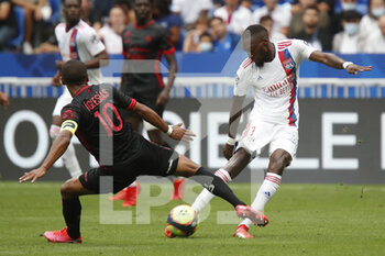 2021-08-22 - Karl TOKO EKAMBI of Lyon and Jonathan IGLESIAS of Clermont during the French championship Ligue 1 football match between Olympique Lyonnais and Clermont Foot 63 on August 22, 2021 at Groupama stadium in Decines-Charpieu near Lyon, France - Photo Romain Biard / Isports / DPPI - OLYMPIQUE LYONNAIS VS CLERMONT FOOT 63 - FRENCH LIGUE 1 - SOCCER