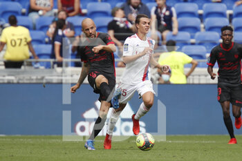 2021-08-22 - Johan GASTIEN of Clermont and Maxence CAQUERET of Lyon during the French championship Ligue 1 football match between Olympique Lyonnais and Clermont Foot 63 on August 22, 2021 at Groupama stadium in Decines-Charpieu near Lyon, France - Photo Romain Biard / Isports / DPPI - OLYMPIQUE LYONNAIS VS CLERMONT FOOT 63 - FRENCH LIGUE 1 - SOCCER