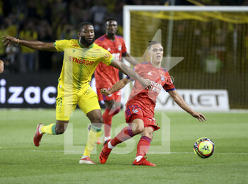2021-08-27 - Maxence Caqueret of Lyon, Marcus Coco of Nantes (left) during the French championship Ligue 1 football match between FC Nantes and Olympique Lyonnais (OL) on August 27, 2021 at Stade de La Beaujoire - Louis Fonteneau in Nantes, France - Photo Jean Catuffe / DPPI - FC NANTES VS OLYMPIQUE LYONNAIS - FRENCH LIGUE 1 - SOCCER