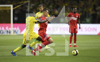 2021-08-27 - Maxence Caqueret of Lyon, Dennis Appiah of Nantes (left) during the French championship Ligue 1 football match between FC Nantes and Olympique Lyonnais (OL) on August 27, 2021 at Stade de La Beaujoire - Louis Fonteneau in Nantes, France - Photo Jean Catuffe / DPPI - FC NANTES VS OLYMPIQUE LYONNAIS - FRENCH LIGUE 1 - SOCCER