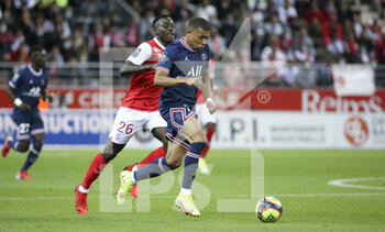 2021-08-29 - Kylian Mbappe of PSG, Dion Lopy of Reims (left) during the French championship Ligue 1 football match between Stade de Reims and Paris Saint-Germain on August 29, 2021 at Auguste Delaune stadium in Reims, France - Photo Jean Catuffe / DPPI - STADE DE REIMS VS PARIS SAINT-GERMAIN - FRENCH LIGUE 1 - SOCCER