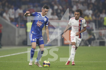 2021-09-12 - Anthony CACI of Strasbourg and Malo GUSTO of Lyon during the French championship Ligue 1 football match between Olympique lyonnais and Racing Club de Strasbourg Alsace on September 12, 2021 at Groupama Stadium in Décines-Charpieu, near Lyon, France - OLYMPIQUE LYONNAIS VS RACING CLUB DE STRASBOURG ALSACE - FRENCH LIGUE 1 - SOCCER