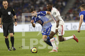 2021-09-12 - Karl TOKO EKAMBI of Lyon and Sanjin PRCIC of Strasbourg during the French championship Ligue 1 football match between Olympique lyonnais and Racing Club de Strasbourg Alsace on September 12, 2021 at Groupama Stadium in Décines-Charpieu, near Lyon, France - OLYMPIQUE LYONNAIS VS RACING CLUB DE STRASBOURG ALSACE - FRENCH LIGUE 1 - SOCCER