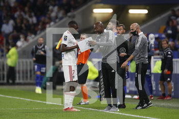 2021-09-25 - Karl TOKO EKAMBI of Lyon and Claudio CACAPA ass-coach of Lyon during the French championship Ligue 1 football match between Olympique Lyonnais and FC Lorient on September 25, 2021 at Groupama stadium in Decines-Charpieu near Lyon, France - OLYMPIQUE LYONNAIS VS FC LORIENT - FRENCH LIGUE 1 - SOCCER
