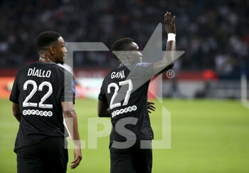 2021-09-25 - Idrissa Gueye Gana of PSG celebrates his goal with Abdou Diallo (left) during the French championship Ligue 1 football match between Paris Saint-Germain (PSG) and Montpellier HSC (MHSC) on September 25, 2021 at Parc des Princes stadium in Paris, France - PARIS SAINT-GERMAIN (PSG) VS MONTPELLIER HSC (MHSC) - FRENCH LIGUE 1 - SOCCER