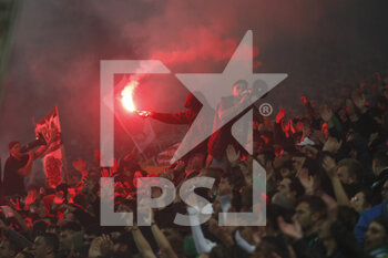 2021-10-03 - Fan with red smoke and fan with megaphone during the French championship Ligue 1 football match between AS Saint-Etienne and Olympique Lyonnais on October 3, 2021 at Geoffroy Guichard stadium in Saint-Etienne, France - AS SAINT-ETIENNE VS OLYMPIQUE LYONNAIS - FRENCH LIGUE 1 - SOCCER