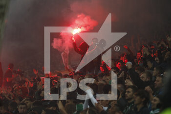 2021-10-03 - Fan with red smoke and fan with megaphone during the French championship Ligue 1 football match between AS Saint-Etienne and Olympique Lyonnais on October 3, 2021 at Geoffroy Guichard stadium in Saint-Etienne, France - AS SAINT-ETIENNE VS OLYMPIQUE LYONNAIS - FRENCH LIGUE 1 - SOCCER