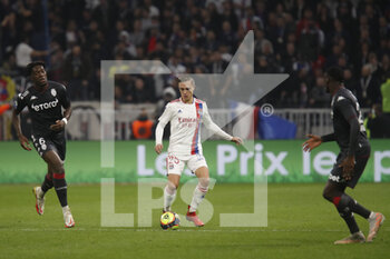 2021-10-16 - Maxence CAQUERET of Lyon and Axel DISASI of Monaco during the French championship Ligue 1 football match between Olympique Lyonnais and AS Monaco on October 16, 2021 at Groupama stadium in Decines-Charpieu near Lyon, France - OLYMPIQUE LYONNAIS VS AS MONACO - FRENCH LIGUE 1 - SOCCER