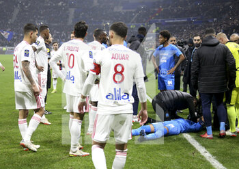 2021-11-21 - Match stopped by referee Ruddy Buquet after few minutes into the game when Dimitri Payet of OM (lying in blue jersey) received a plastic water bottle on the head thrown from the OL kop during the French championship Ligue 1 football match between Olympique Lyonnais (OL) and Olympique de Marseille (OM) on November 21, 2021 at Groupama stadium in Decines-Charpieu near Lyon, France - OLYMPIQUE LYONNAIS (OL) VS OLYMPIQUE DE MARSEILLE (OM) - FRENCH LIGUE 1 - SOCCER