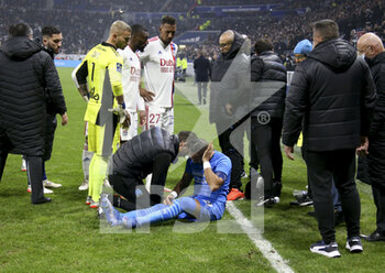 2021-11-21 - Match stopped by referee Ruddy Buquet after few minutes into the game when Dimitri Payet of OM (lying in blue jersey) received a plastic water bottle on the head thrown from the OL kop during the French championship Ligue 1 football match between Olympique Lyonnais (OL) and Olympique de Marseille (OM) on November 21, 2021 at Groupama stadium in Decines-Charpieu near Lyon, France - OLYMPIQUE LYONNAIS (OL) VS OLYMPIQUE DE MARSEILLE (OM) - FRENCH LIGUE 1 - SOCCER