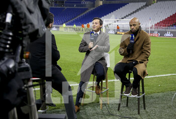 2021-11-21 - President of Olympique de Marseille Pablo Longoria and Thierry Henry, pundit for Amazon Prime Video react after the match was stopped after few minutes when Dimitri Payet of OM received a plastic water bottle on the head thrown from the OL kop during the French championship Ligue 1 football match between Olympique Lyonnais (OL) and Olympique de Marseille (OM) on November 21, 2021 at Groupama stadium in Decines-Charpieu near Lyon, France - OLYMPIQUE LYONNAIS (OL) VS OLYMPIQUE DE MARSEILLE (OM) - FRENCH LIGUE 1 - SOCCER