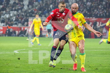 2021-11-27 - Duel Burak YILMAZ 17 LOSC and Nicolas PALLOIS 4 Nantes during the French championship Ligue 1 football match between LOSC Lille and FC Nantes on November 27, 2021 at Pierre Mauroy stadium in Villeneuve-d'Ascq near Lille, France - LOSC LILLE VS FC NANTES - FRENCH LIGUE 1 - SOCCER