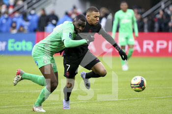 2021-11-28 - Kylian Mbappe of PSG, Mickael Nade of Saint-Etienne (left) during the French championship Ligue 1 football match between AS Saint-Etienne (ASSE) and Paris Saint-Germain (PSG) on November 28, 2021 at Stade Geoffroy Guichard in Saint-Etienne, France - AS SAINT-ETIENNE (ASSE) VS PARIS SAINT-GERMAIN (PSG) - FRENCH LIGUE 1 - SOCCER