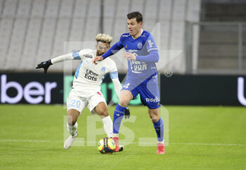 2021-11-28 - Giulian Biancone of Troyes, Konrad De La Fuente of Marseille (left) during the French championship Ligue 1 football match between Olympique de Marseille and ESTAC Troyes on November 28, 2021 at Orange Velodrome stadium in Marseille, France - OLYMPIQUE DE MARSEILLE VS ESTAC TROYES - FRENCH LIGUE 1 - SOCCER