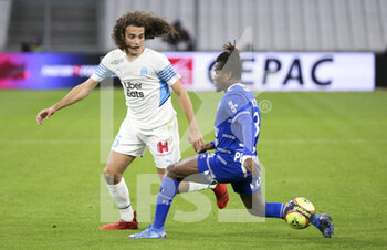 2021-11-28 - Matteo Guendouzi of Marseille, Youssouf Kone of Troyes during the French championship Ligue 1 football match between Olympique de Marseille and ESTAC Troyes on November 28, 2021 at Orange Velodrome stadium in Marseille, France - OLYMPIQUE DE MARSEILLE VS ESTAC TROYES - FRENCH LIGUE 1 - SOCCER