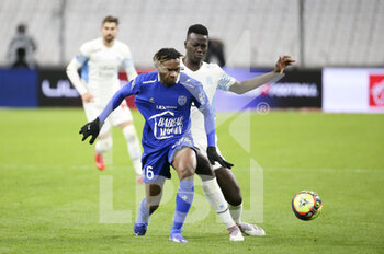 2021-11-28 - Rominigue Kouame of Troyes, Pape Gueye of Marseille during the French championship Ligue 1 football match between Olympique de Marseille and ESTAC Troyes on November 28, 2021 at Orange Velodrome stadium in Marseille, France - OLYMPIQUE DE MARSEILLE VS ESTAC TROYES - FRENCH LIGUE 1 - SOCCER