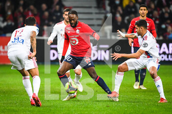 2021-12-12 - Jonathan IKONE of Lille and Bruno GUIMARAES of Lyon during the French championship Ligue 1 football match between LOSC Lille and Olympique Lyonnais (Lyon) on December 12, 2021 at Pierre Mauroy stadium in Villeneuve-d'Ascq near Lille, France - LOSC LILLE VS OLYMPIQUE LYONNAIS (LYON) - FRENCH LIGUE 1 - SOCCER