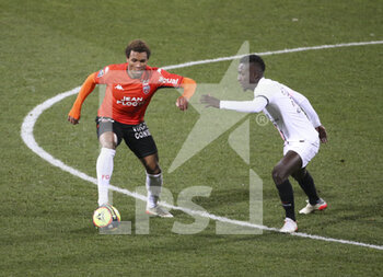 2021-12-22 - Armand Lauriente of Lorient, Idrissa Gueye Gana of PSG during the French championship Ligue 1 football match between Fc Lorient (FCL) and Paris Saint-Germain (PSG) on December 22, 2021 at Stade du Moustoir in Lorient, France - FC LORIENT (FCL) VS PARIS SAINT-GERMAIN (PSG) - FRENCH LIGUE 1 - SOCCER