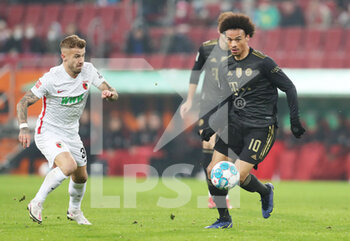 2021-11-19 - Leroy Sane of Bayern Munich and Niklas Dorsch of Augsburg during the German championship Bundesliga football match between FC Augsburg and Bayern Munich on November 19, 2021 at WWK Arena in Augsburg, Germany - FC AUGSBURG VS BAYERN MUNICH - GERMAN BUNDESLIGA - SOCCER