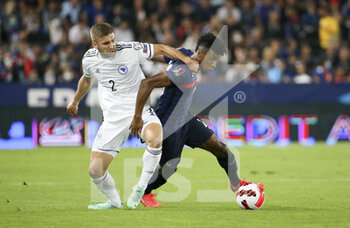 2021-09-01 - Kingsley Coman of France, Eldar Civic of Bosnia and Herzegovina (left) during the FIFA World Cup Qatar 2022, Qualifiers, Group D football match between France and Bosnia and Herzegovina on September 1, 2021 at Stade de La Meinau in Strasbourg, France - FIFA WORLD CUP QATAR 2022, QUALIFIERS, GROUP D - FRANCE AND BOSNIA AND HERZEGOVINA - FIFA WORLD CUP - SOCCER