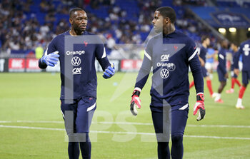 2021-09-07 - Goalkeepers of France Steve Mandanda, Mike Maignan during the FIFA World Cup Qatar 2022, Qualifiers, Group D football match between France and Finland on September 7, 2021 at Groupama stadium in Decines-Charpieu near Lyon, France - FIFA WORLD CUP QATAR 2022, QUALIFIERS, GROUP D - FRANCE AND FINLAND - FIFA WORLD CUP - SOCCER