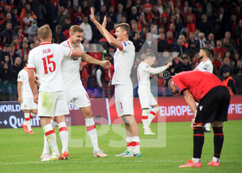2021-10-12 - Helik (Poland) celebrating with Glik (Poland) and Dawidowicz (Poland) after scoring a goal during the 2022 FIFA World Cup qualifiers football match between Albania and Polandf on October 13, 2021 at Air Albania Stadium in Tirana, Albania - 2022 FIFA WORLD CUP - QUALIFIERS - ALBANIA VS POLAND - FIFA WORLD CUP - SOCCER