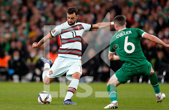 2021-11-11 - Bruno Fernandes of Portugal and Josh Cullen of Ireland during the FIFA World Cup 2022, Qualifiers Group A football match between Republic of Ireland and Portugal on November 11, 2021 at Aviva Stadium in Dublin, Republic of Ireland - REPUBLIC OF IRELAND VS PORTUGAL - FIFA WORLD CUP - SOCCER