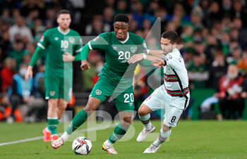 2021-11-11 - Chiedozie Ogbene of Ireland and Joao Moutinho of Portugal during the FIFA World Cup 2022, Qualifiers Group A football match between Republic of Ireland and Portugal on November 11, 2021 at Aviva Stadium in Dublin, Republic of Ireland - REPUBLIC OF IRELAND VS PORTUGAL - FIFA WORLD CUP - SOCCER