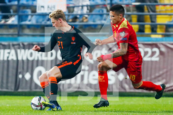 2021-11-13 - Frenkie de Jong of the Netherlands battles for the ball with Uros Djurdjevic of Montenegro during the FIFA World Cup 2022, Qualifiers Group G football match between Montenegro and Netherlands on November 13, 2021 at Gradski Stadion Podgorica in Podgorica, Montenegro - FIFA WORLD CUP 2022, QUALIFIERS GROUP G - MONTENEGRO VS NETHERLANDS - FIFA WORLD CUP - SOCCER