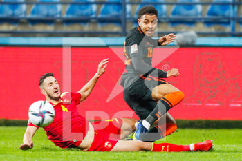 2021-11-13 - Nikola Vukcevic of Montenegro battles for the ball with Donyell Malen of the Netherlands during the FIFA World Cup 2022, Qualifiers Group G football match between Montenegro and Netherlands on November 13, 2021 at Gradski Stadion Podgorica in Podgorica, Montenegro - FIFA WORLD CUP 2022, QUALIFIERS GROUP G - MONTENEGRO VS NETHERLANDS - FIFA WORLD CUP - SOCCER