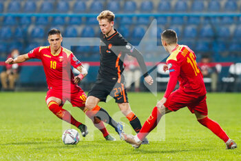 2021-11-13 - Frenkie de Jong of the Netherlands battles for the ball with Vladimir Jovovic of Montenegro and Uros Djurdjevic of Montenegro during the FIFA World Cup 2022, Qualifiers Group G football match between Montenegro and Netherlands on November 13, 2021 at Gradski Stadion Podgorica in Podgorica, Montenegro - FIFA WORLD CUP 2022, QUALIFIERS GROUP G - MONTENEGRO VS NETHERLANDS - FIFA WORLD CUP - SOCCER