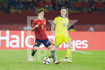 2021-11-14 - Pablo Martin Paez Gavira "Gavi" of Spain and Kristoffer Olsson of Sweden during the FIFA World Cup 2022, Qualifiers Group B football match between Spain and Sweden on November 14, 2021 at La Cartuja stadium in Sevilla, Spain - FIFA WORLD CUP 2022, QUALIFIERS GROUP B - SPAIN VS SWEDEN - FIFA WORLD CUP - SOCCER