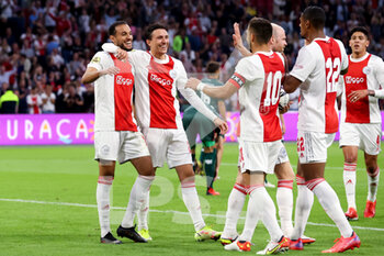 2021-08-14 - Noussair Mazraoui of Ajax celebrates with Steven Berghuis of Ajax after scoring his sides second goal during the Netherlands championship Eredivisie football match between Ajax and NEC on August 14, 2021 at the Johan Cruijff ArenA in Amsterdam, Netherlands - Photo Herman Dingler / Orange Pictures / DPPI - AJAX VS NEC - NETHERLANDS EREDIVISIE - SOCCER