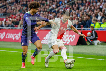 2021-10-24 - Andre Ramalho of PSV battles for the ball with Dusan Tadic of Ajax during the Netherlands championship Eredivisie football match between Ajax and PSV on October 24, 2021 at Johan Cruijff Arena in Amsterdam, Netherlands - AJAX VS PSV - NETHERLANDS EREDIVISIE - SOCCER