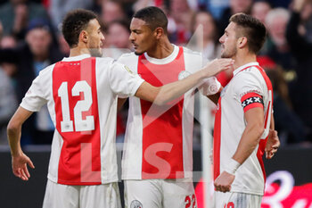 2021-10-24 - Sebastien Haller of Ajax celebrates after scoring his sides second goal with Noussair Mazraoui of Ajax and Dusan Tadic of Ajax during the Netherlands championship Eredivisie football match between Ajax and PSV on October 24, 2021 at Johan Cruijff Arena in Amsterdam, Netherlands - AJAX VS PSV - NETHERLANDS EREDIVISIE - SOCCER