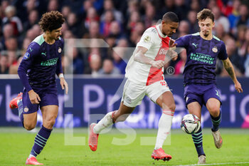 2021-10-24 - Sebastien Haller of Ajax battles for the ball with Andre Ramalho of PSV and Olivier Boscagli of PSV during the Netherlands championship Eredivisie football match between Ajax and PSV on October 24, 2021 at Johan Cruijff Arena in Amsterdam, Netherlands - AJAX VS PSV - NETHERLANDS EREDIVISIE - SOCCER