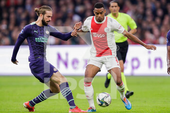 2021-10-24 - Davy Propper of PSV battles for the ball with Ryan Gravenberch of Ajax during the Netherlands championship Eredivisie football match between Ajax and PSV on October 24, 2021 at Johan Cruijff Arena in Amsterdam, Netherlands - AJAX VS PSV - NETHERLANDS EREDIVISIE - SOCCER
