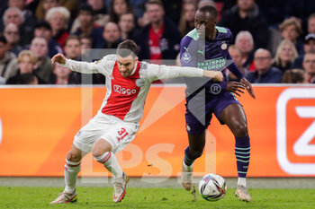 2021-10-24 - Nico Tagliafico of Ajax battles for the ball with Jordan Teze of PSV during the Netherlands championship Eredivisie football match between Ajax and PSV on October 24, 2021 at Johan Cruijff Arena in Amsterdam, Netherlands - AJAX VS PSV - NETHERLANDS EREDIVISIE - SOCCER