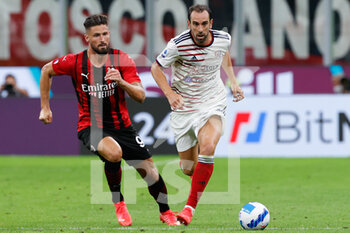 2021-08-29 - Diego Godin (Cagliari Calcio) in action hindered by Olivier Giroud (AC Milan) - AC MILAN VS CAGLIARI CALCIO - ITALIAN SERIE A - SOCCER