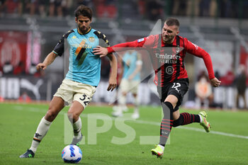 2021-09-22 - Ante Rebic of AC Milan fights for the ball against Pietro Ceccaroni of Venezia FC during the Serie A 2021/22 football match between AC Milan and Venezia FC at Giuseppe Meazza Stadium, Milan, Italy on September 22, 2021 - AC MILAN VS VENEZIA FC - ITALIAN SERIE A - SOCCER