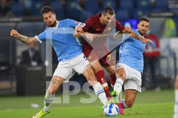 2021-09-26 - ROME, ITALY -  September 26 : Henrikh Mikitarian (C) of  AS Roma in action against  Francesco Acerbi  (L) at Danilo Cataldi (R) of SS Lazio during the  Serie A  soccer match between  SS Lazio and AS Roma Stadio Olimpico on September 26,2021  in Rome Italy 
 - SS LAZIO VS AS ROMA - ITALIAN SERIE A - SOCCER