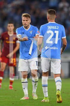 2021-09-26 - ROME, ITALY - September 26 :  Ciro Immobile from the band at Sergej Milinkovic of SS Lazio in Action during the  Serie A soccer match between SS Lazio and  AS Roma at Stadio Olimpico on September 26,2021 in Rome, Italy  
 - SS LAZIO VS AS ROMA - ITALIAN SERIE A - SOCCER